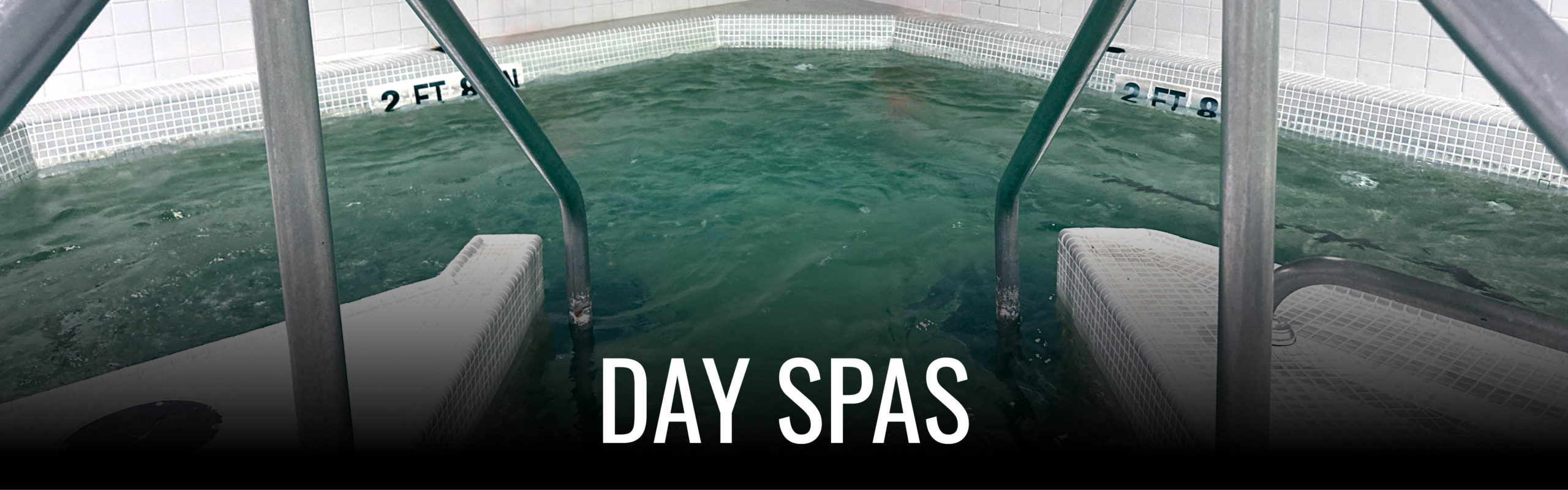 View from inside a spa pool looking out towards the open water with the words 'DAY SPAS' overlaid at the bottom.