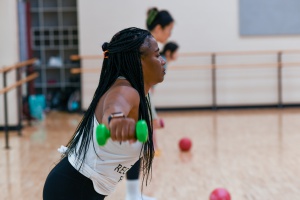 Group Fitness Instructor lifting weights in one of the fitness classes