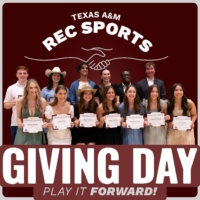 Group of Texas A&M Rec Sports student scholarship recipients smiling and holding certificates under a “Giving Day – Play It Forward” banner.