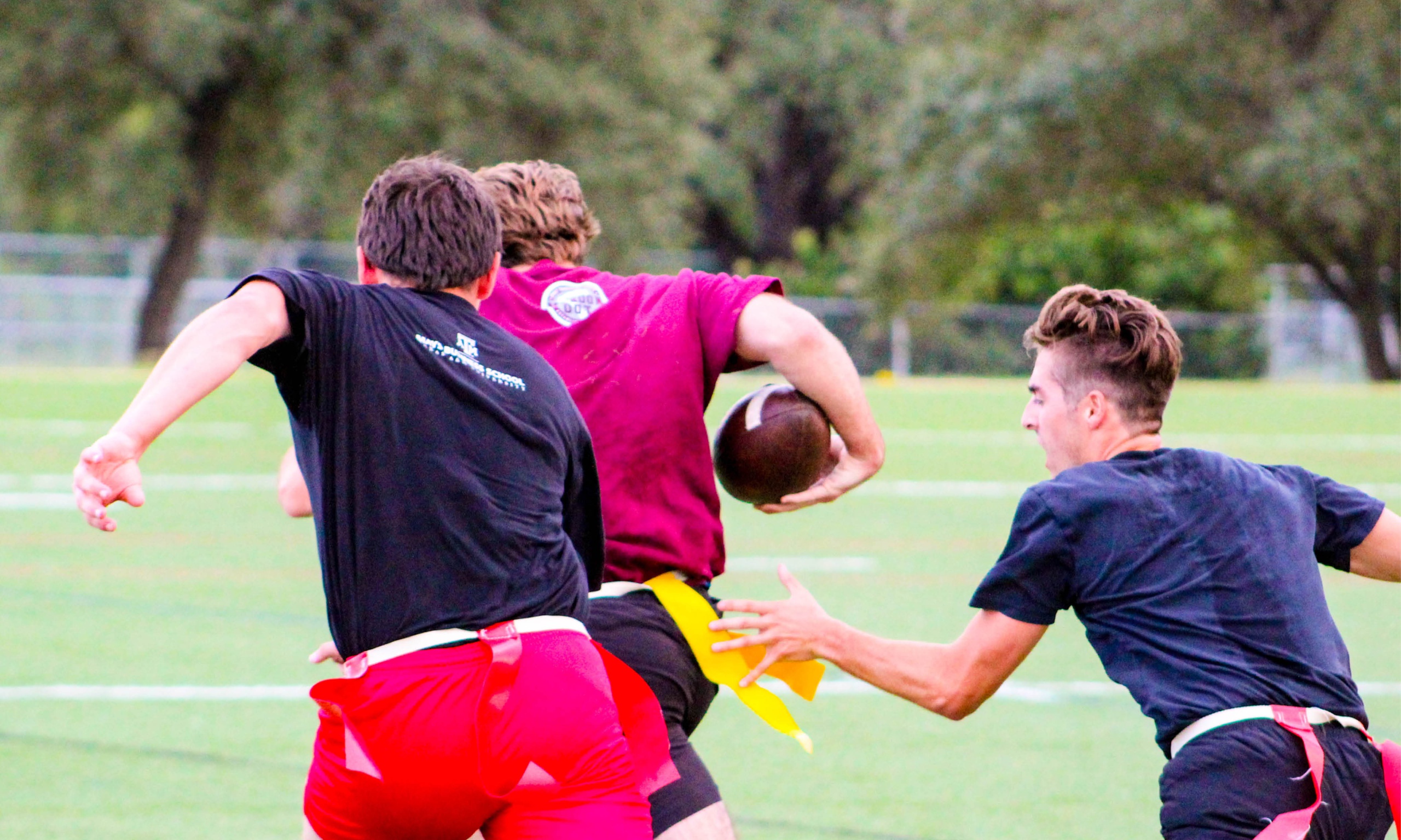An energetic gathering of individuals playing Intramural football.