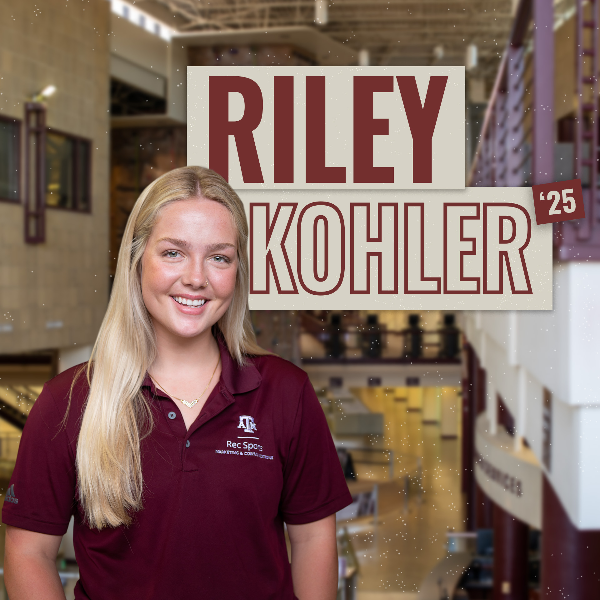 Portrait of Riley Kohler, class of '25, wearing a polo shirt with the Rec Sports logo, smiling in front of the Student Rec Center lobby.