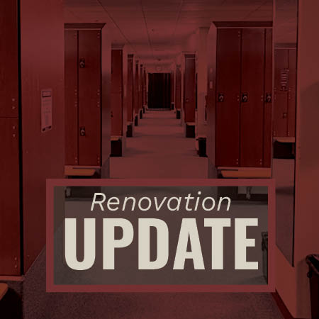 Image shows the locker room with open lockers on both sides, illuminated with red lighting. A sign in the foreground reads 'Renovation UPDATE'.