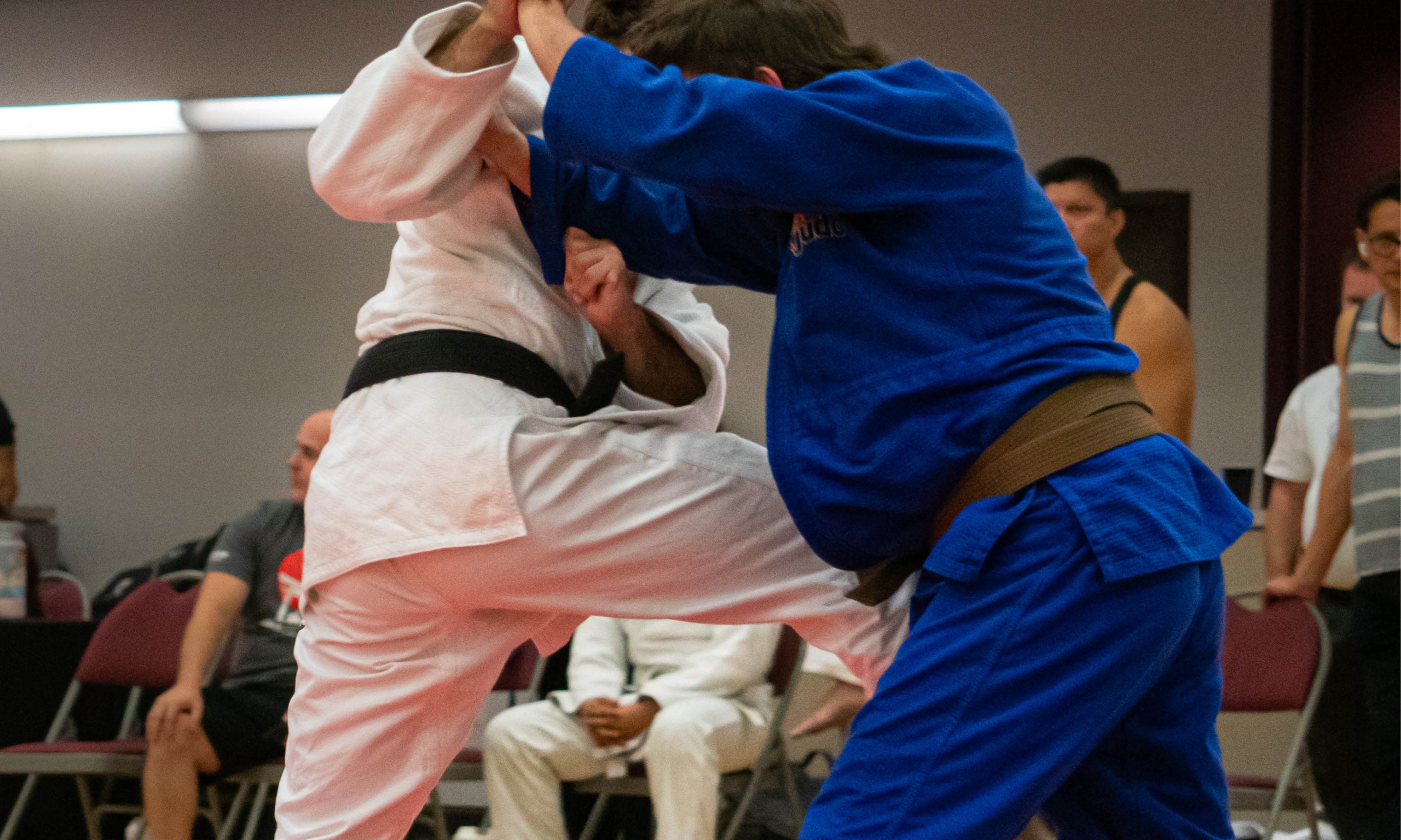 Two men competing in a Judo tournament.