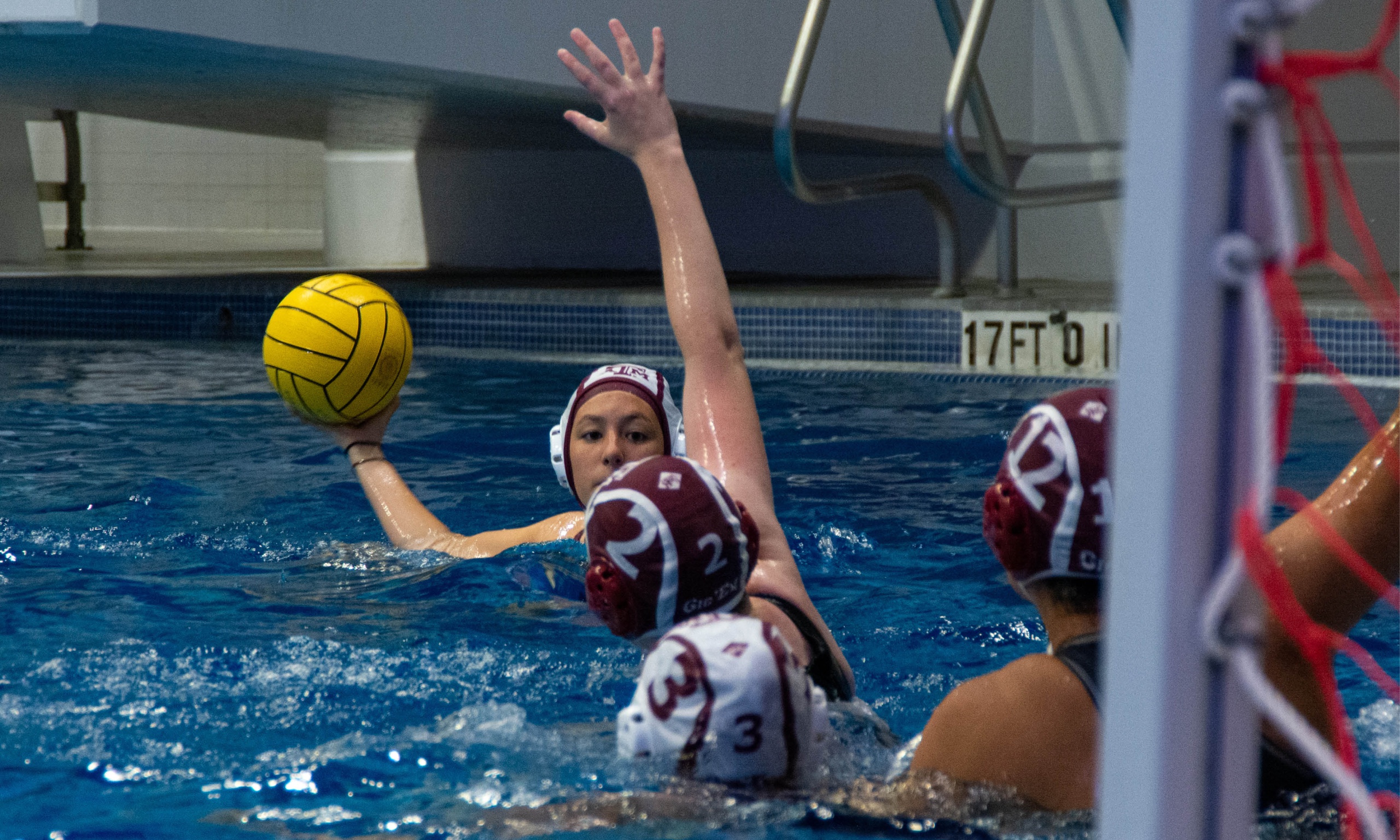 Women's water polo playing a game in teh pools at the Student Rec Center in College Station, tx.