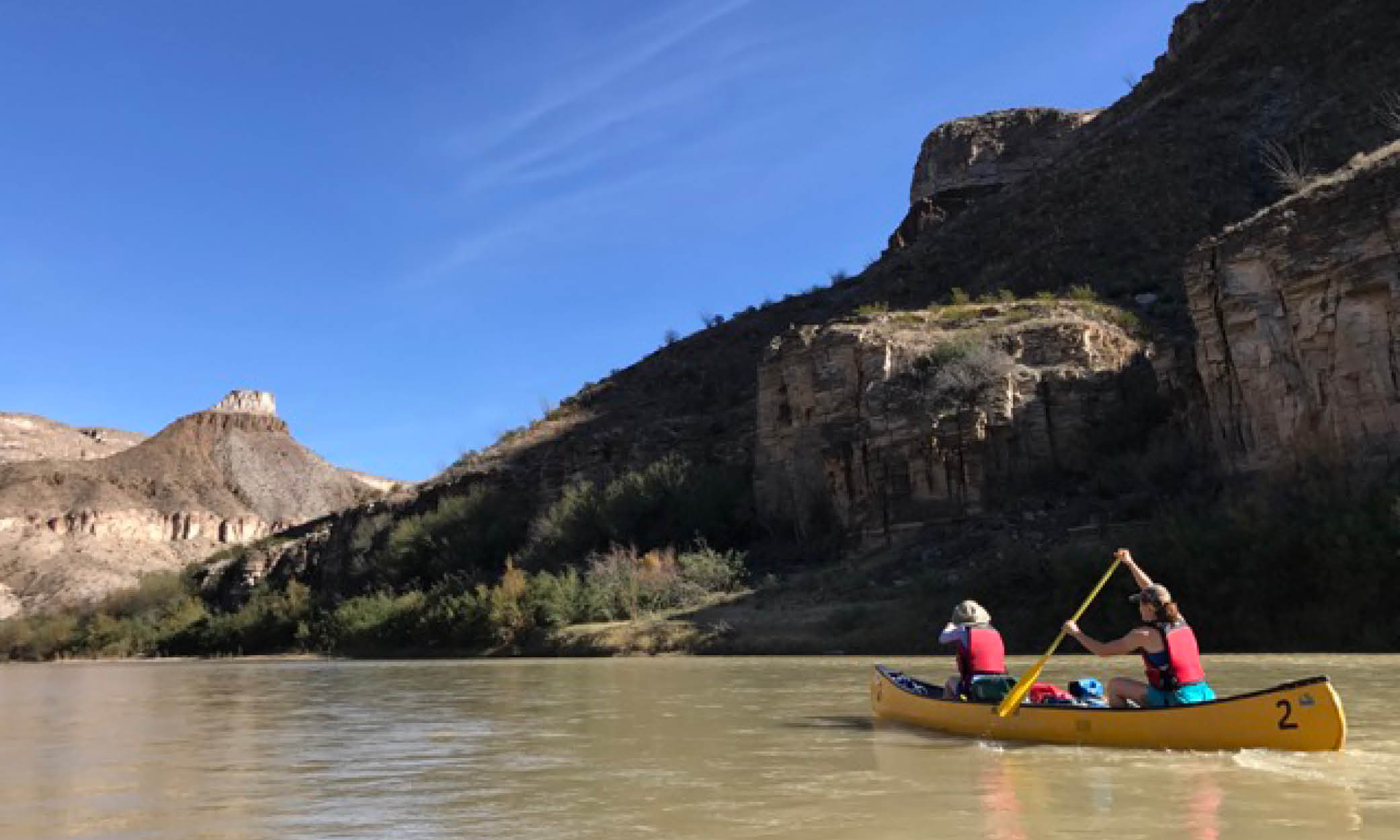 Two people on a canoe trip in Big Bend Canyons