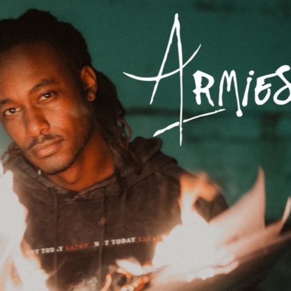 Promotional image for the artist Armies featuring the person holding a flame, set against a moody greenish backdrop with the name 'Armies' displayed prominently in stylized white script.