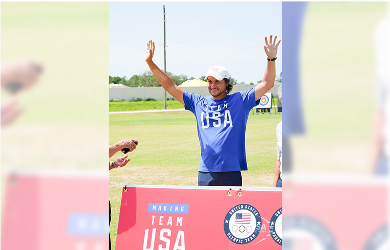 Trenton Cowles is holding his hands up while being recognized on making the USA Mens Archery Olympic Team at the USA Archery Olympic Trials.
